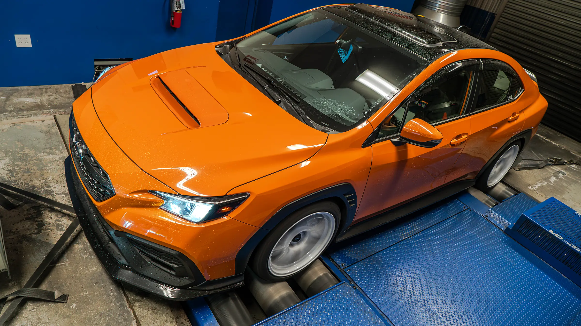 Orange WRX strapped to the dyno